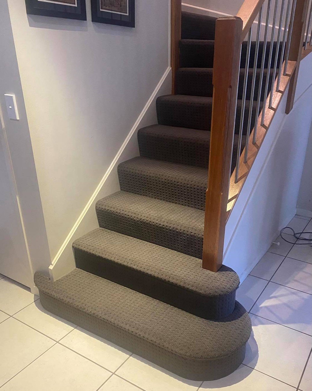 Carpeted stairs with timber balustrade