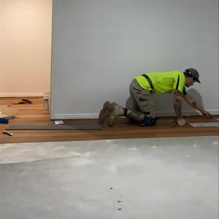Eli laying plank on a prepped subfloor